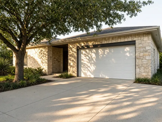 White garage door on a stone-front home